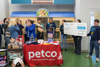 Winning adopter and school shooting survivor Drew Pescaro and his dog Lilly celebrate a $50,000 grant award with the team from Peak Lab Rescue.
