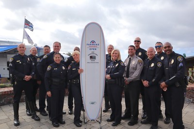 Farmers Insurance Open Hometown Hero Award recipient Officer Deborah Ganely (left of the surfboard) is pictured with her unit after accepting the inaugural award.