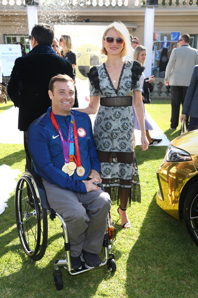 Actress Naomi Watts and Paralympian Tennis Player David Wagner bond near the BMW Beverly Hills gold-dipped M8 at the 7th Annual Gold Meets Golden Event, presented by Coca-Cola, BMW Beverly Hills and FASHWIRE.
