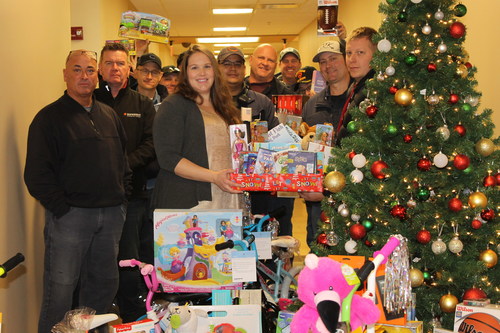 Volunteers with some of the donated toys.
