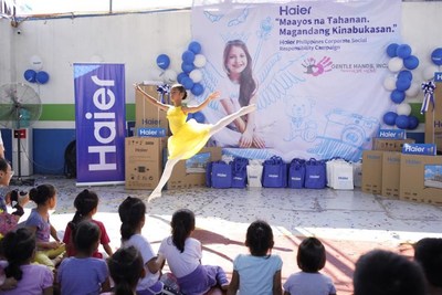 Photo taken on July 5, 2019 shows a girl dances at the donation ceremony of Haier in a welfare house of the Philippines.