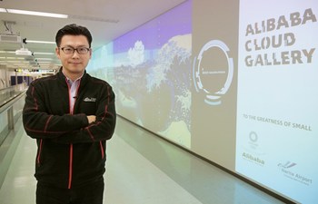 Alibaba Group Chief Marketing Officer Chris Tung in front of Alibaba Cloud Gallery at Narita Airport.