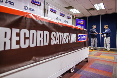 SNICKERS breaks the Guinness World Record title for largest chocolate nut bar on Thursday, Jan. 16, 2020, in Waco, Texas. The more than two tons candy bar was made using a 1200 pound combination of caramel, nougat and peanuts, and 3500 pounds of chocolate.  (Drew Anthony Smith/AP Images for SNICKERS)