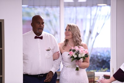PruittHealth – Augusta Hills administrator, Ashlyn Broderick, is walked down the aisle by Claude Epps, a resident at the facility, during her wedding ceremony on Monday, Dec. 23, 2019 in Augusta, Ga. (Sean Rayford/AP Images for PruittHealth)