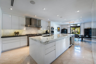 The kitchen, with a clean and elegant aesthetic, was designed with the help of a gourmet chef, and offers a robust suite of appliances by Miele, Sub-Zero and Wolf. The oversized island was custom-built from just two slabs of Calacatta marble. MiamiLuxuryAuction.com.