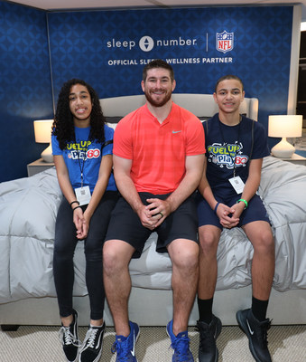 Miami Dolphins linebacker Mike Hull congratulates Florida students Kayla Bello and Alberth Polanco for being selected as two of Sleep Number’s Super Sleep Contest winner in partnership with GENYOUth, on Sunday, Jan. 26 at Super Bowl Experience in Miami, Florida.