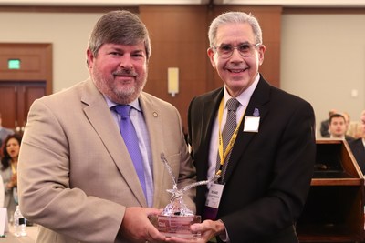 Dr. Richard Weinman presents the Georgia Dental Association 2019 Legislator of the Year award to Georgia Senator Larry Walker, III.