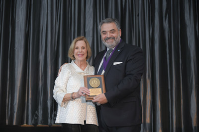 Dr. Susan E. Brackett (left) receives the Distinguished Service Award from ACP Immediate Past President Dr. Nadim Z. Baba at the 49th Annual Session of the ACP held in Miami.