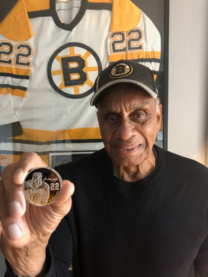 NHL trailblazer Willie O'Ree holds the Royal Canadian Mint's Black History Month coin bearing his engraved portrait. Fredericton-born O’Ree was the first black person to play in the NHL. (CNW Group/Royal Canadian Mint)