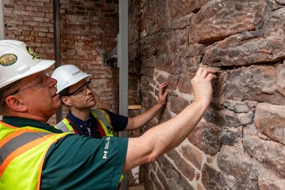 Province House National Historic Site conservation project managers, Greg Shaw from Parks Canada (left) and Tim Chandler from Public Service and Procurement Canada (right), assess the condition of the interior masonry wall prior to restoration work. Credit: Parks Canada (CNW Group/Parks Canada)