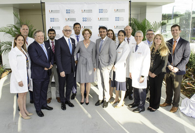 Jayne Sylvester Malfitano (center), vice chair, Sylvester Board of Overseers, flanked by Dr. Stephen D. Nimer (left), director, Sylvester Comprehensive Cancer Center, and Dr. Amit Rastogi (right), president and CEO, Jupiter Medical Center, with physicians and clinical staff from both institutions.