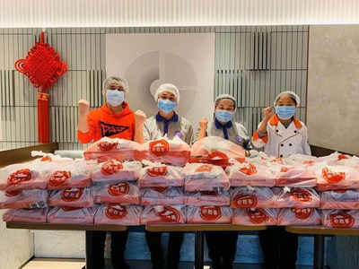 Staff volunteers preparing food donated to support medical workers in Wuhan