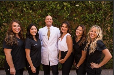 Dr. Michael Barnes, D.D.S., center, surrounded by staff members.