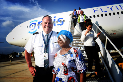 Volunteer Pilot, Captain Pete Pitzer, escorts a patient after she received sight-saving cataract surgery. Photo: Geoff Oliver Bugbee | Ghana 2019