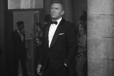 PHOTO CREDIT: B25_36559_bw_RC2James Bond (Daniel Craig) inNO TIME TO DIE,an EON Productions and Metro Goldwyn Mayer Studios film Credit: Nicola Dove© 2020 DANJAQ, LLC AND MGM. ALL RIGHTS RESERVED.PRODUCT DETAILS: TOM FORD Black Wool Atticus Shawl Collar Cocktail Jacket with Quilted Satin Lapel and Cuffs, Atticus Evening Trouser, White Poplin Collared Shirt, Black Satin Self Bowtie, Black Satin Cummerbund and Off White Silk Pocket Square