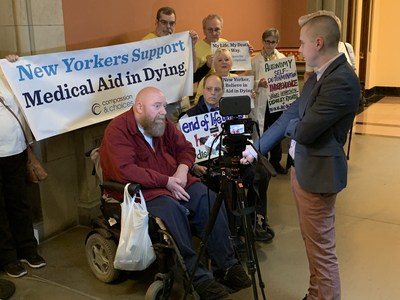 Gene Hughes of Utica, NY, who has been in a wheelchair since an automobile accident in 1983, tells reporter at New York State Capitol why he supports the New York Medical Aid in Dying Act.