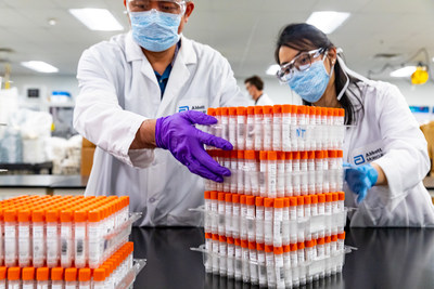 Abbott scientists and engineers prepare coronavirus test kits for shipment.