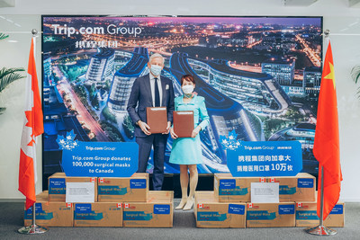 Trip.com Group CEO Jane Sun (right) presents a donation to Canadian Ambassador to China Dominic Barton (left). (PRNewsfoto/Trip.com Group)