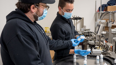 Brendan McDermott and Alex Althaus looking over production line