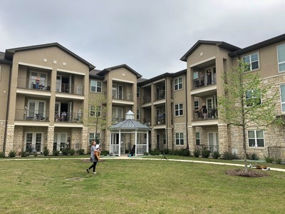 Residents at The Enclave at Round Rock Senior Living enjoy music and dancing from their balconies.