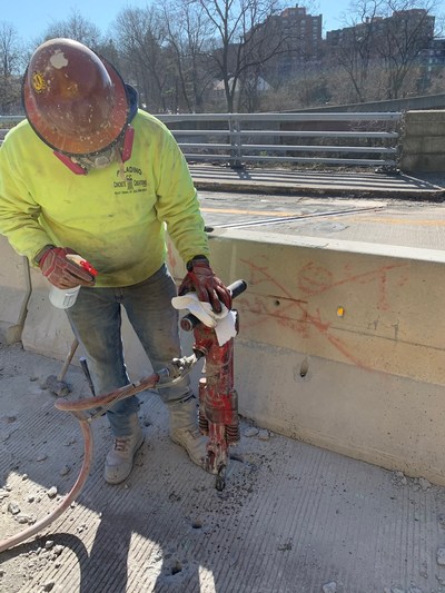 A member of Heavy Construction Laborers Local 60 disinfects a jackhammer before working on the Bronx River Parkway.