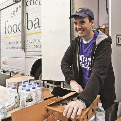 A Knight of Columbus in Connecticut assists with a food bank delivery