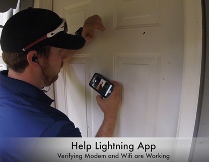 Technician Brandon Bishop using On-site Virtual Assist tool to confirm that customer’s service is working properly from outside the home during recent visit.