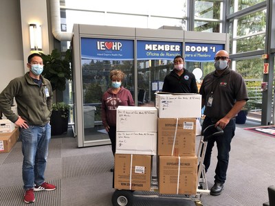 IEHP’s Business Continuity Director Philip Lo, Senior Facilities Coordinator Christopher Aguas and Facilities Coordinator Marquis Wilson present 7,500 surgical masks to SBCMS's Membership Director Soteria Cobb.