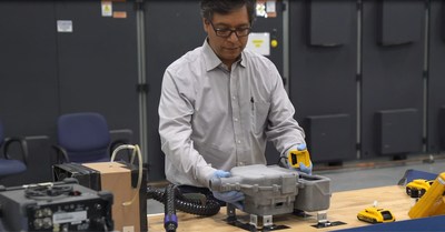Engineer assembles battery system for the new PAPR design. (Image from Ford)