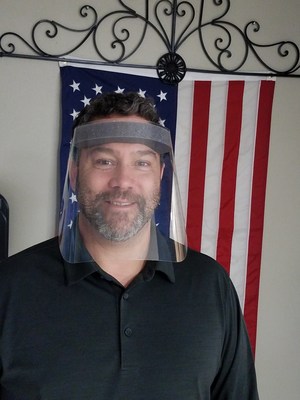 Demco's manufacturing director, Chad Fryer, models one of the new face shields the company is producing for healthcare personnel in Wisconsin.