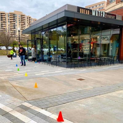 Social distancing cones mark where to stand for curbside pickup customers outside of Bread & Water Company's Pentagon Row location in Arlington, VA.
