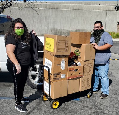 IEHP's Eva Aparicio and Kevinn Porras gather boxes of hygiene products for distribution to local senior living apartments.