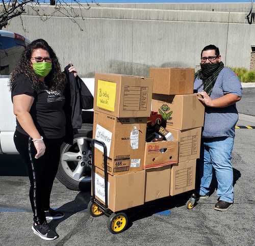 IEHP’s Eva Aparicio and Kevinn Porras gather boxes of hygiene products for distribution to local senior living apartments.