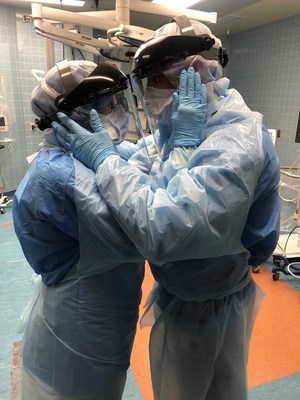Ben Cayer and Mindy Brock, both certified nurse anesthetists with Tampa General Hospital, take a moment to embrace during the COVID-19 pandemic. Photo credit: Nicole Hubbard, CRNA