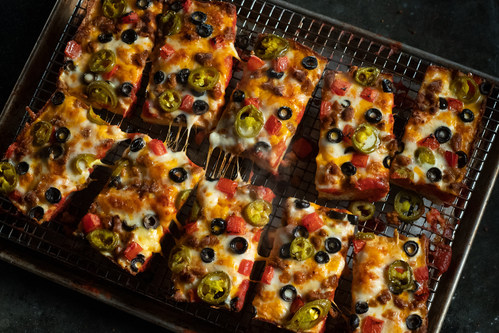 The Mexican Pizza from Jet's, loaded with zesty chorizo, premium mozzarella, cheddar cheese, black olives, diced tomatoes, and jalapeño.