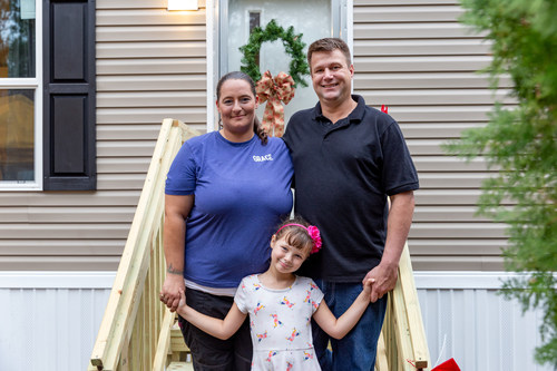 Zovak-Ryan family stands in front of their new Clayton Built® home.