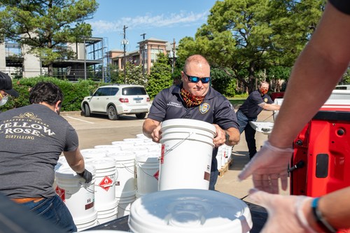 Members of the Houston Fire Department pick-up nearly 500 gallons of hand sanitizer donated from Houston's Yellow Rose Distilling.
