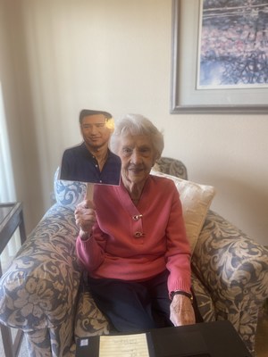 A resident at Lincoln Meadows Senior Living holds up a picture of Mario Lopez.