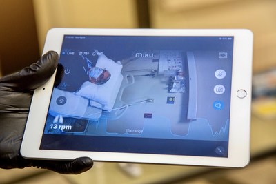 A nurse uses an iPad to view respiratory data from Miku's contactless respiratory monitor.