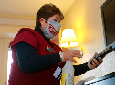 Red Roof housekeeper, Margarita Chavez sanitizes in-room high touchpoints, including TV remotes as part of  Red Roof RediClean which includes rigorous enhanced cleaning protocols that address the new normal and give consumers the confidence they need to hit the road again.