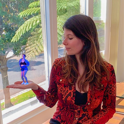 Project Producer, Carolina Rizzotto, holding Laura's hologram in the palm of her hand.