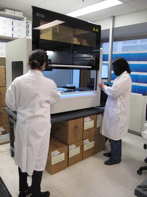 Technicians with MGISP-960 automated sample preparation and liquid handling system at Mount Sinai Hospital Microbiology lab