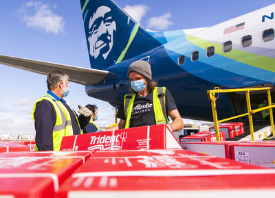 Alaska Air Cargo employees begin to unload 9,000 pounds of Copper River salmon, part of the first shipment to arrive in Seattle.