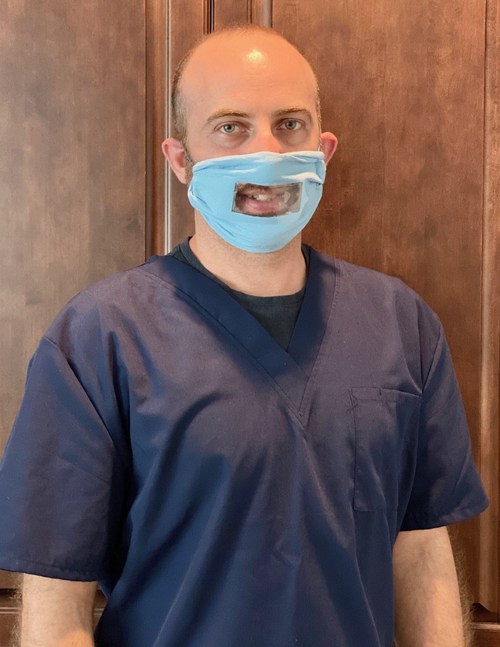 Dr. Sandler demonstrating a clear mask.