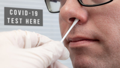 Man having a Nasal Swab test for Coronavirus with sign