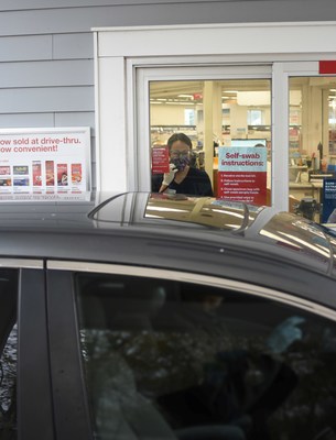 A CVS Pharmacy technician observes a patient administer a self-swab COVID-19 test at one of the company's drive-thru testing locations throughout the country. Photo Courtesy CVS Health