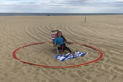 The Beach Ring is a stainless spring steel, 6-inch nylon band that is 12 feet diameter, giving individuals inside the ring a 6-foot radius around them.