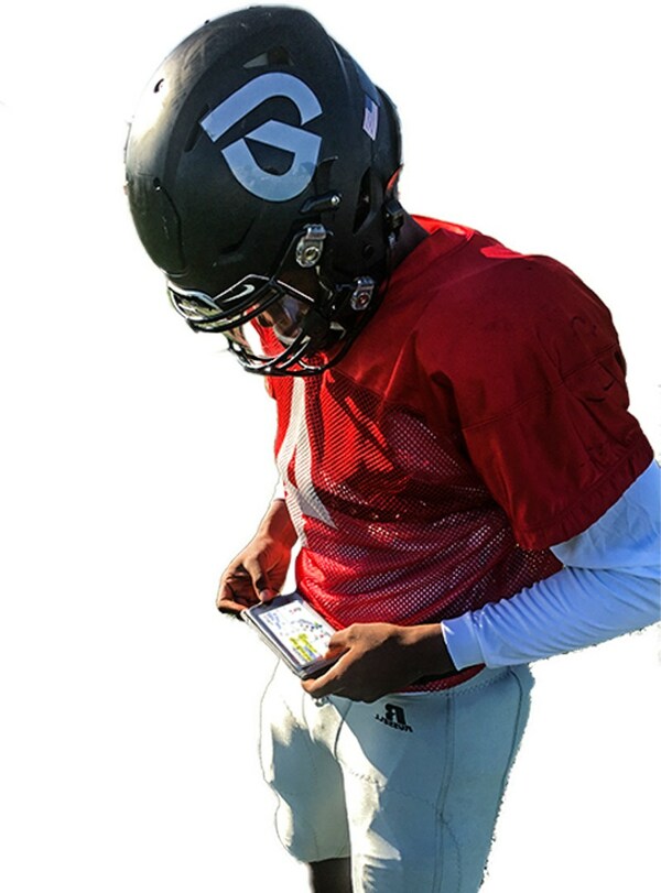 Player is looking at his GoRout device after receiving a play call from a coach.