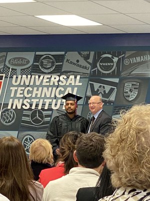 Dylan Bansi, with UTI-Exton Campus President Bob Kessler at his graduation ceremony, now works as a Peterbilt technician and has kept trucks maintained, running and delivering critical goods during the Pandemic.