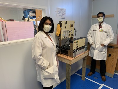 Doctors Amrita John and Shine Raju at UH Cleveland Medical Center with the device that decontaminates masks using atomic oxygen. Courtesy: University Hospitals